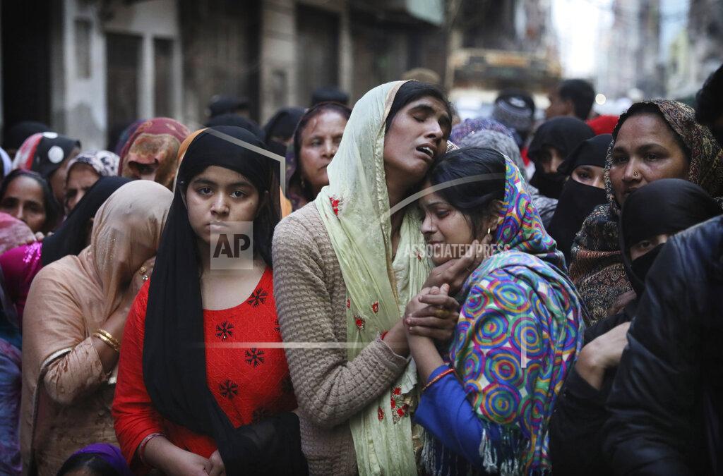 Manish Swarup FILE - In this Thursday, Feb. 27, 2020, file photo, relatives and neighbors wail near the body of Mohammad Mudasir, 31, who was killed in communal violence in New Delhi, India. Many of the Muslim victims of last year's bloody violence say they have run repeatedly into a refusal by police to investigate complaints against Hindu rioters. Some hope the courts will still come to their help. But others now believe the justice system under Prime Minister Narendra Modi's Hindu-nationalist government has become stacked against them. (AP Photo/Manish Swarup, File)