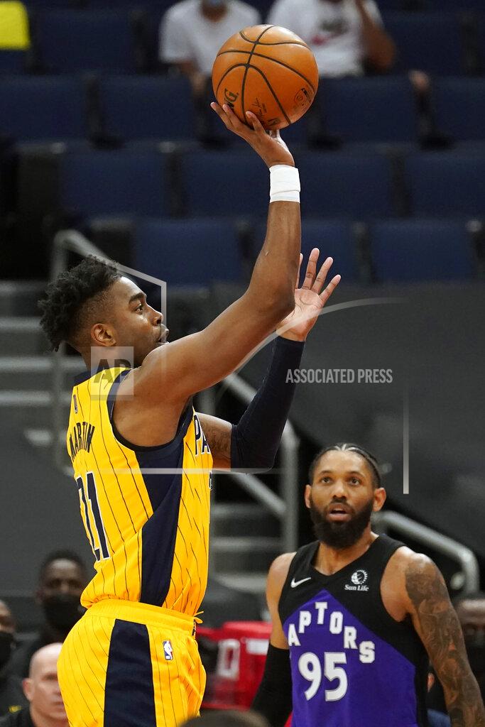 Chris O'meara Indiana Pacers guard Kelan Martin (21) shoots over Toronto Raptors guard DeAndre' Bembry (95) during the first half of an NBA basketball game Sunday, May 16, 2021, in Tampa, Fla. (AP Photo/Chris O'Meara)