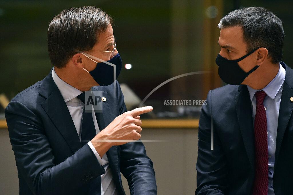 John Thys Dutch Prime Minister Mark Rutte, left, speaks with Spain's Prime Minister Pedro Sanchez during a round table meeting at an EU summit in Brussels, Monday, July 20, 2020. Weary European Union leaders are expressing cautious optimism that a deal is in sight on their fourth day of wrangling over an unprecedented budget and coronavirus recovery fund. (John Thys, Pool Photo via AP)