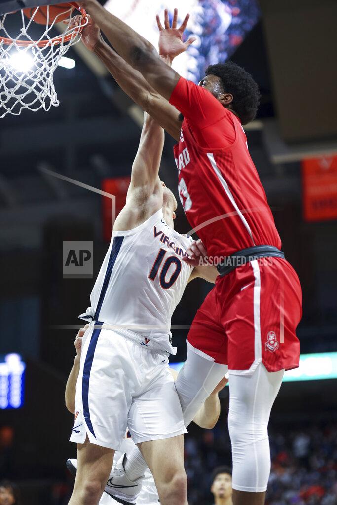 Andrew Shurtleff Radford forward Shaquan Jules (13) dunks the ball over Virginia guard Taine Murray (10) during an NCAA college basketball game in Charlottesville, Va., Friday, Nov. 12, 2021. (AP Photo/Andrew Shurtleff)