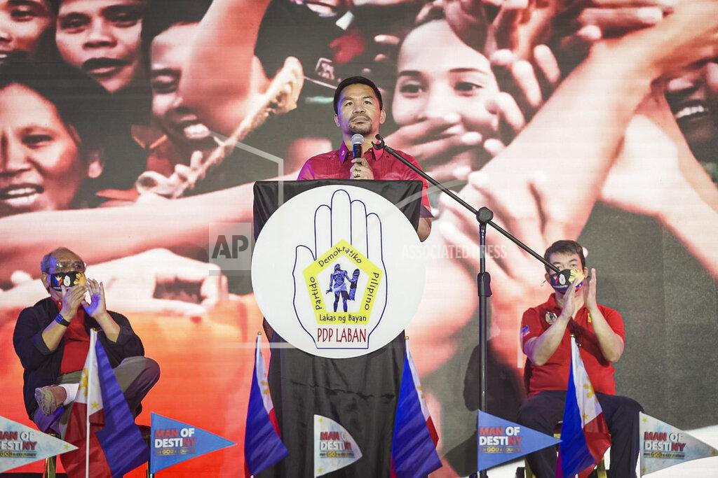 Uncredited In this photo provided by the Manny Pacquiao MediaComms, Senator Manny Pacquiao, center, speaks during a national convention of his PDP-Laban party in Quezon city, Philippines on Sunday Sept. 19, 2021. Philippine boxing icon and senator Manny Pacquiao says he will run for president in the 2022 elections. (Manny Pacquiao MediaComms via AP)
