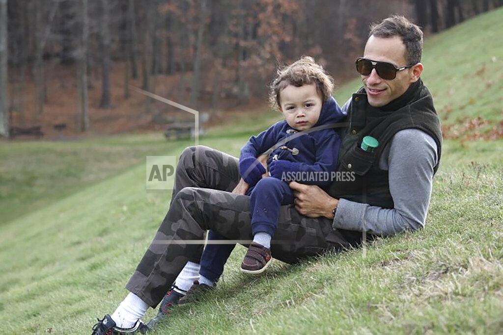 Allison Andrade-Cullen In this Sept. 2014 photo provided by Allison Andrade-Cullen, her husband Flavio Andrade Prado, a Brazilian national, right, holds their son Gabriel Andrade-Cullen, left, while visiting Hopkinton State Park, in Hopkinton, Mass. Andrade Prado is being held by Immigration and Customs Enforcement, or ICE, at the Plymouth County House of Corrections. The number of detainees nationwide has more than doubled since the end of February, to nearly 27,000, according to recent data from U.S. Immigration and Customs Enforcement. (Allison Andrade-Cullen via AP)