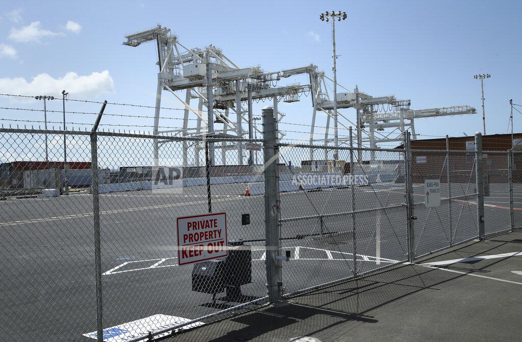 Ben Margot FILE — In this April 12, 2018 file, photo cranes for loading and unloading cargo are seen at the Howard terminal area of the Port of Oakland in Oakland, Calif. The Oakland City Council approved preliminary terms for a new $12 billion waterfront ballpark project for the Athletics, Tuesday, July 20, 2021. But it's not clear if the 6-1 vote will be enough to keep the A's at the negotiating table instead of leaving the city. (AP Photo/Ben Margot, File)