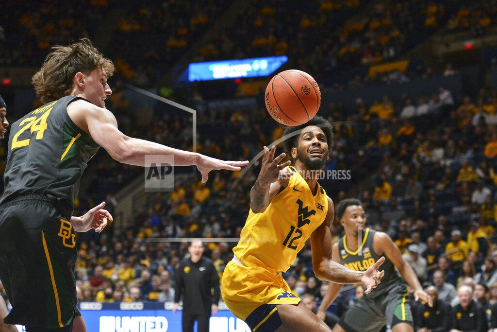 William Wotring West Virginia guard Taz Sherman (12) and Baylor guard Matthew Mayer (24) vie for a loose ball during the first half of an NCAA college basketball game in Morgantown, W.Va., Tuesday, Jan. 18, 2022. (William Wotring)