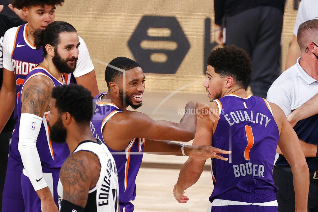 Kevin C. Cox Phoenix Suns' Devin Booker (1) celebrates with teammate Mikal Bridges after scoring the game winning basket against the Los Angeles Clippers in an NBA basketball game Tuesday, Aug. 4, 2020, in Lake Buena Vista, Fla. (Kevin C. Cox/Pool Photo via AP)