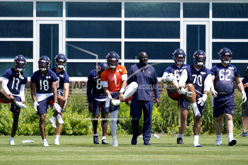 Nam Y. Huh Chicago Bears quarterback Justin Fields (1) stretches on the field with teammates during NFL football practice in Lake Forest, Ill., Wednesday, June 9, 2021. (AP Photo/Nam Y. Huh)