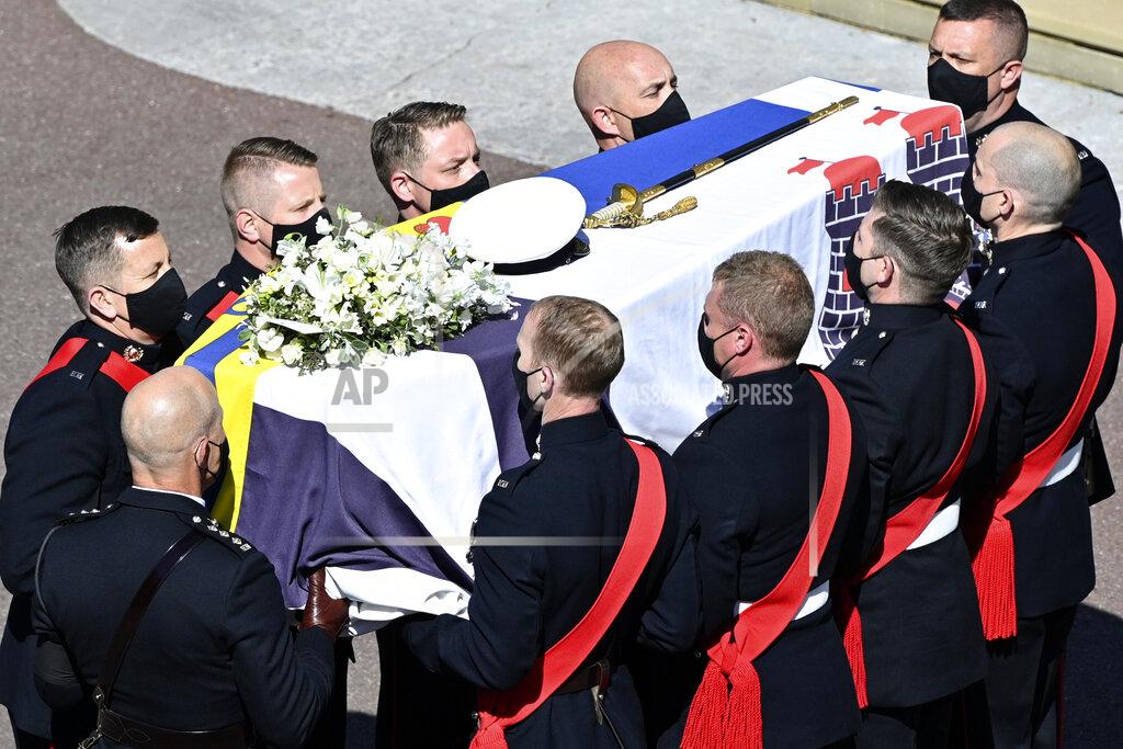 Justin Tallis Pall bearers carry the coffin arriving at St George's Chapel for the funeral of Britain's Prince Philip inside Windsor Castle in Windsor, England, Saturday, April 17, 2021. Prince Philip died April 9 at the age of 99 after 73 years of marriage to Britain's Queen Elizabeth II. (Justin Tallis/Pool via AP)