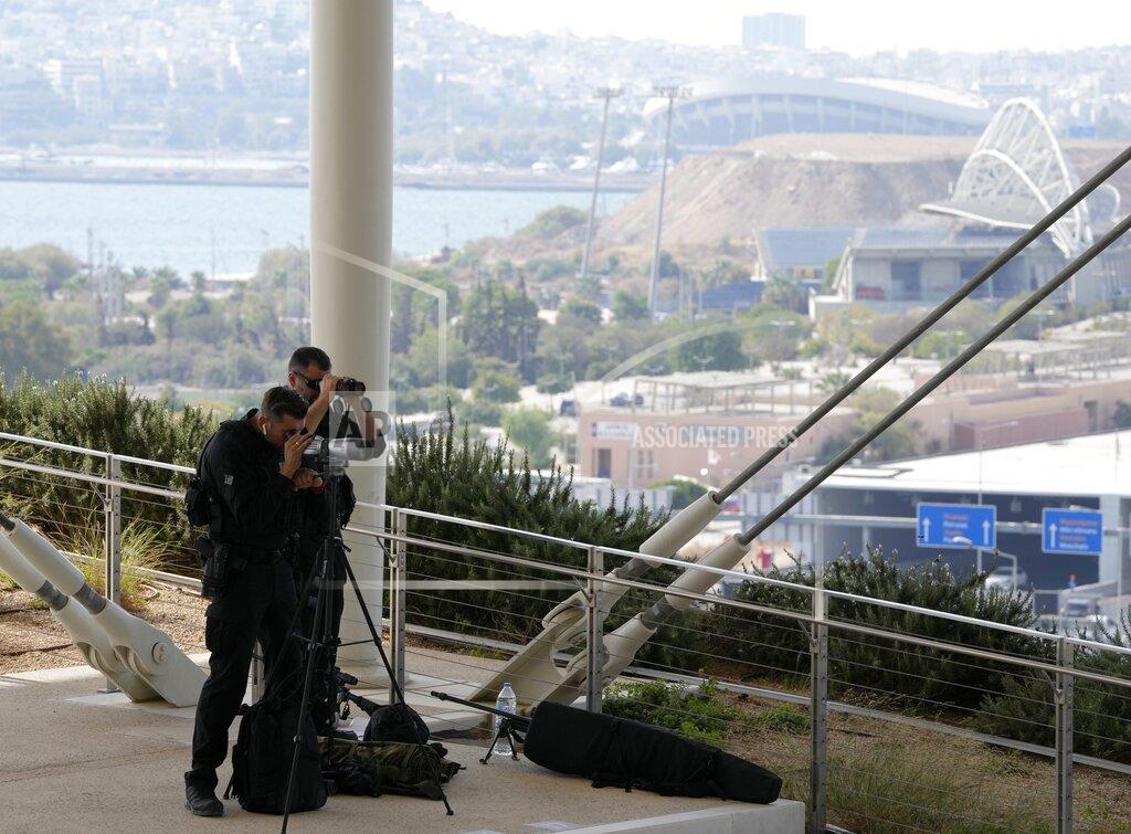 Thanassis Stavrakis Police guard during the EUMED 9 summit at the Stavros Niarchos Foundation Cultural Center in Athens, Friday, Sept. 17, 2021. Nine European countries on the Mediterranean are holding a summit in Athens to discuss issues ranging from climate change and the pandemic response to migration and Afghanistan. (AP Photo/Thanassis Stavrakis)