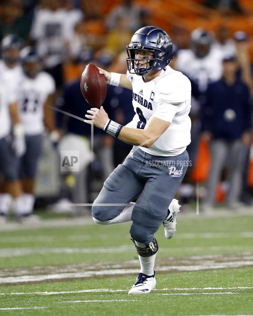 Marco Garcia Nevada quarterback Kaymen Cureton (8) runs for yards against Hawaii during the second quarter of an NCAA college football game, Saturday, Oct. 20, 2018, in Honolulu. (AP Photo/Marco Garcia)