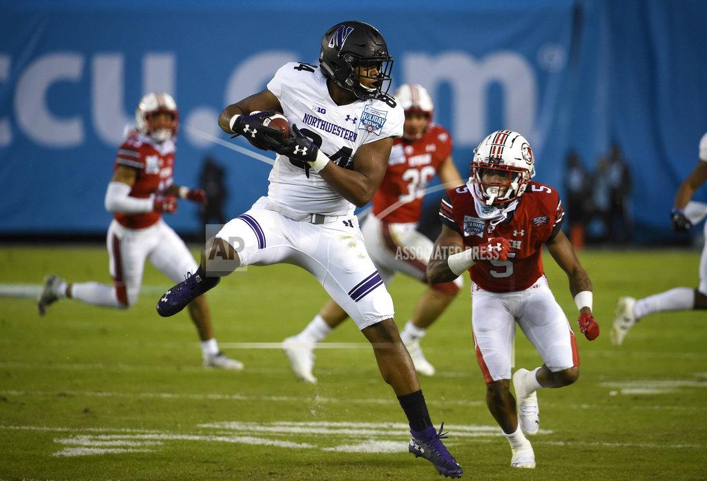 Denis Poroy Northwestern wide receiver Cameron Green (84) makes a catch in front of the defense of Utah defensive back Tareke Lewis (5) during the first half of the Holiday Bowl NCAA college football game Monday, Dec. 31, 2018, in San Diego. (AP Photo/Denis Poroy)
