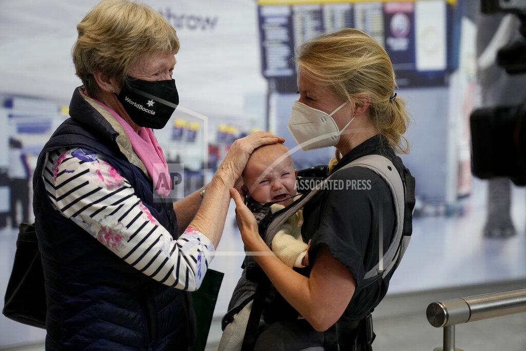 Matt Dunham Susan Handfield, left, meets her baby granddaughter Charlotta for the first time, held by her mother Eva as they arrive from a Berlin flight at Terminal 5 of Heathrow Airport in London, Monday, Aug. 2, 2021. Travelers fully vaccinated against coronavirus from the United States and much of Europe were able to enter Britain without quarantining starting today, a move welcomed by Britain's ailing travel industry. (AP Photo/Matt Dunham)