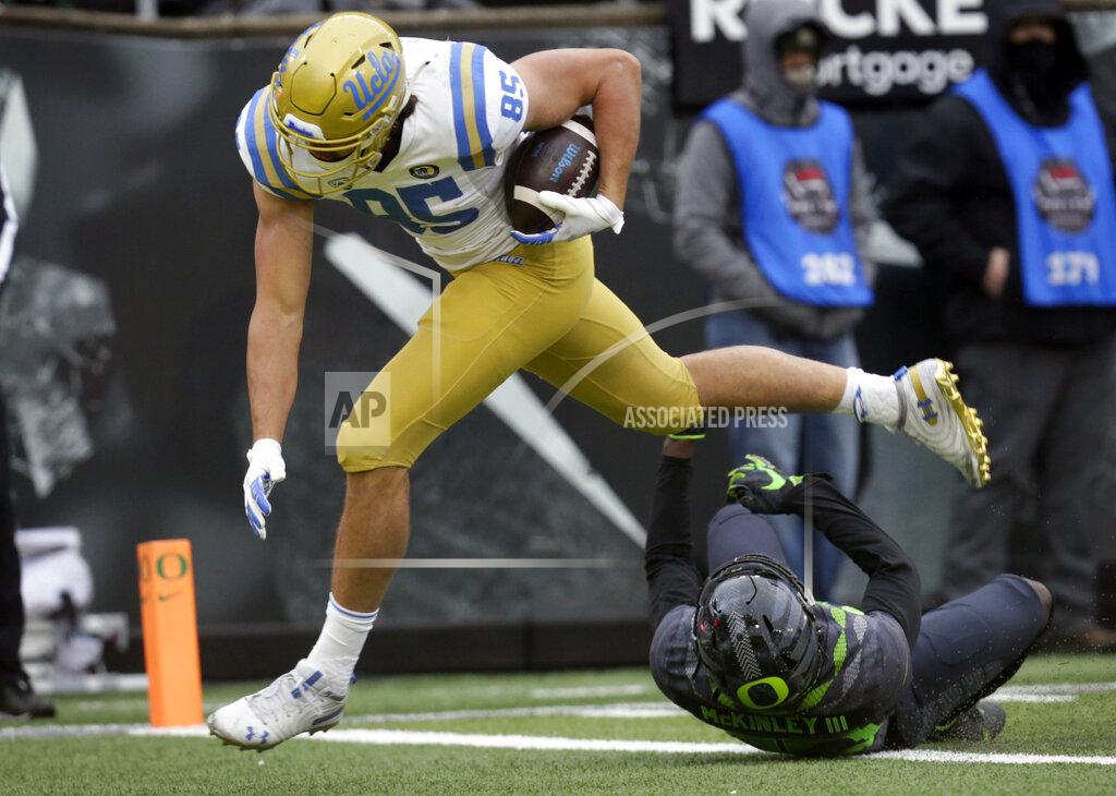 Chris Pietsch UCLA'S Greg Dulcich scores a touchdown against Oregon during the third quarter of an NCAA college football game Saturday, Nov. 21, 2020, in Eugene, Ore. (AP Photo/Chris Pietsch)