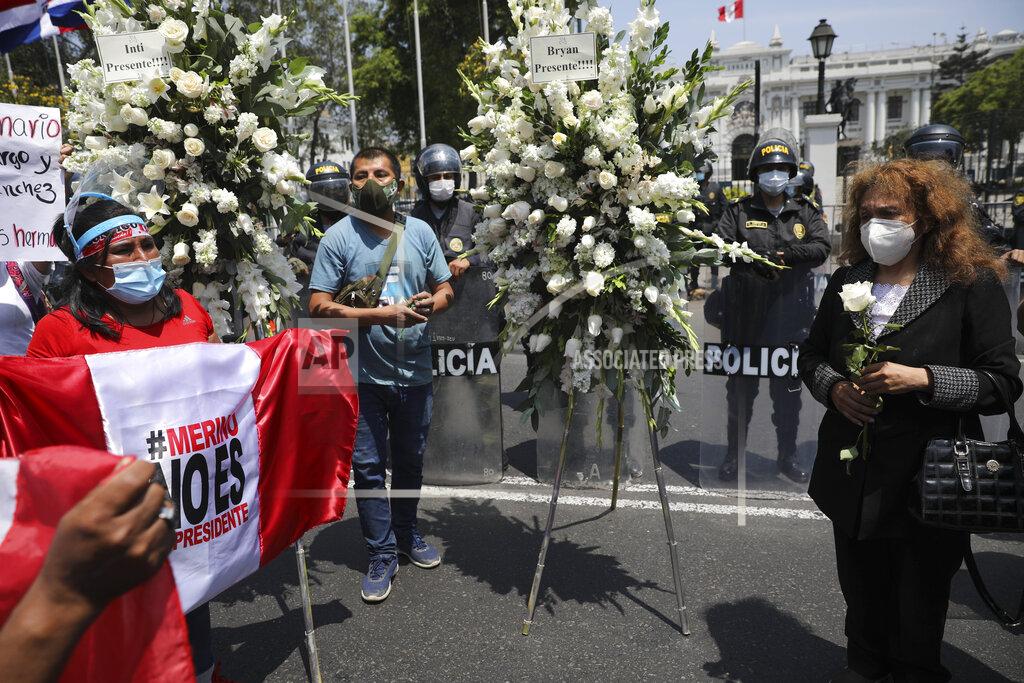 Rodrigo Abd Protesters asking for the resignation of interim President Manuel Merino attend a ceremony for two people killed during protests, outside the Congress in Lima, Peru, Sunday, Nov. 15, 2020. Merino stepped down Sunday following a wave of protests against the dismissal by Congress of President Martin Vizcarra. (AP Photo/Rodrigo Abd)