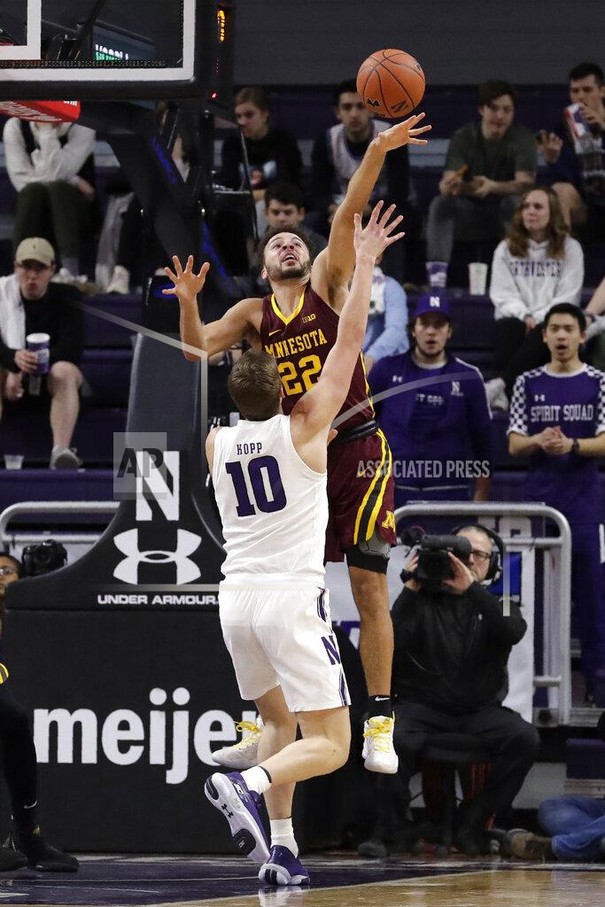 Nam Y. Huh Minnesota guard Gabe Kalscheur, top, blocks a shot by Northwestern forward Miller Kopp during the first half of an NCAA college basketball game in Evanston, Ill., Sunday, Feb. 23, 2020. (AP Photo/Nam Y. Huh)