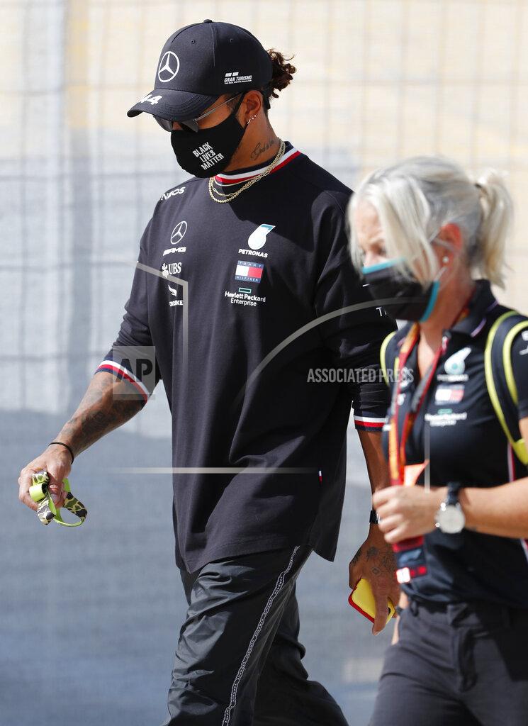 Armando Franca Mercedes driver Lewis Hamilton of Britain, left, walks near the track prior to the Formula One Portuguese Grand Prix at the Algarve International Circuit in Portimao, Portugal, Thursday, Oct. 22, 2020. The Formula One Portuguese Grand Prix will take place on Sunday. (AP Photo/Armando Franca)