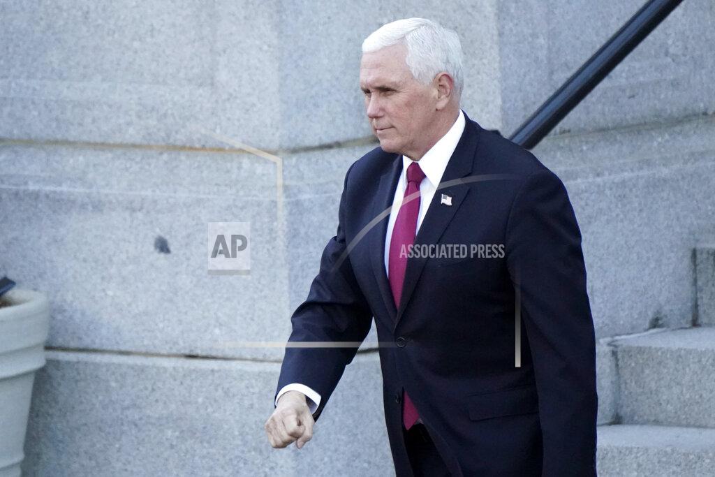 Gerald Herbert Vice President Mike Pence walks to the West Wing of the White House after addressing staff on the steps of the Eisenhower Executive Office Building, in the White House complex, Tuesday, Jan. 19, 2021, in Washington. (AP Photo/Gerald Herbert)