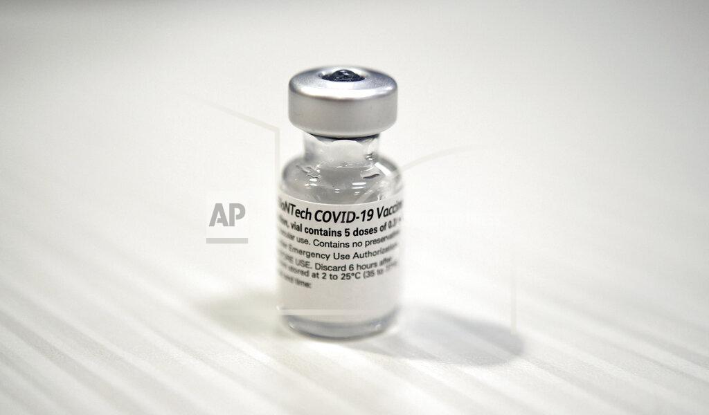 One of the first vials of the Pfizer BioNTech COVID-19 vaccine at Wake Forest Baptist Medical Center, Tuesday, Dec. 15, 2020. Wake Forest Baptist received its first shipment of the Pfizer vaccine on Monday morning. Ten employees received the first dose of the Pfizer vaccine Tuesday. Additional employees will be given the vaccine in the coming days. (Walt Unks/The Winston-Salem Journal via AP)