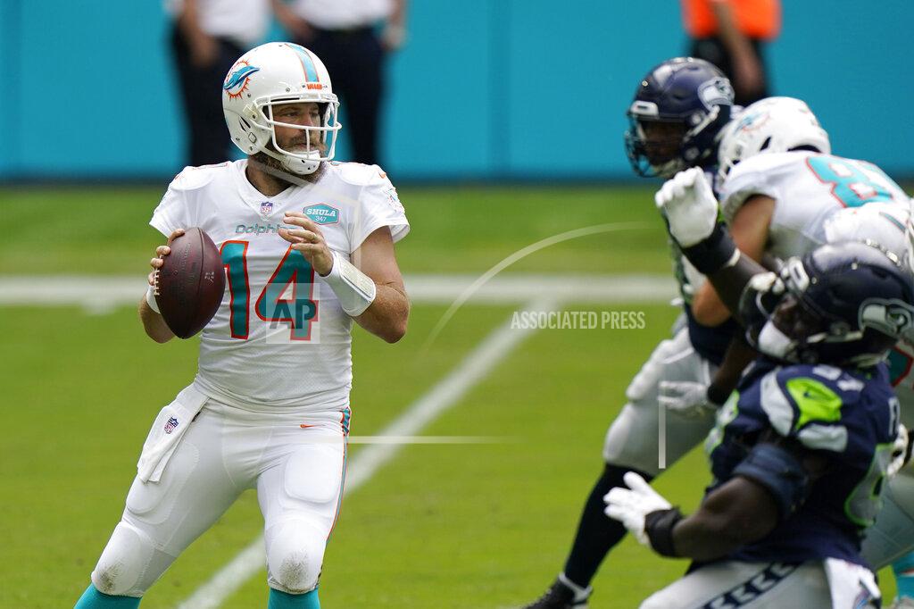 Wilfredo Lee Miami Dolphins quarterback Ryan Fitzpatrick (14) looks to pass the ball during the first half of an NFL football game against the Seattle Seahawks, Sunday, Oct. 4, 2020 in Miami Gardens, Fla. (AP Photo/Wilfredo Lee)