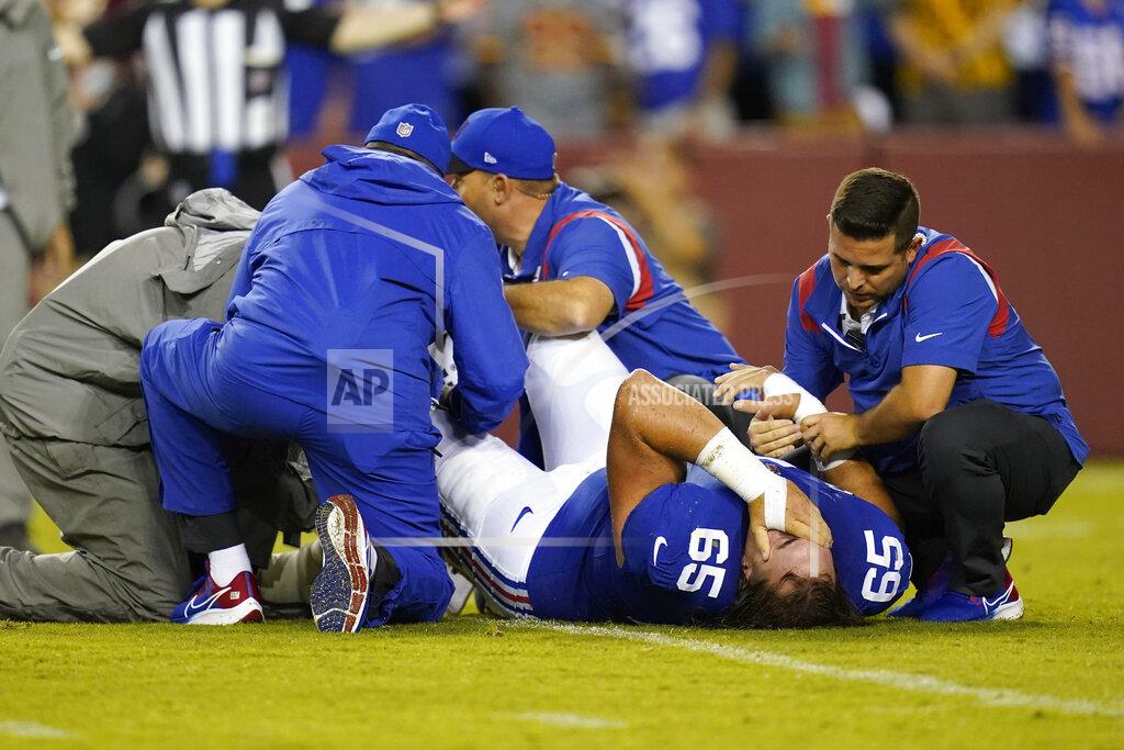 Patrick Semansky New York Giants center Nick Gates (65) lays on the field as members of the team medical staff tend to him during the first half of an NFL football game against the Washington Football Team, Thursday, Sept. 16, 2021, in Landover, Md. Gates sustained an injury on the play and was carted off the field. (AP Photo/Patrick Semansky)