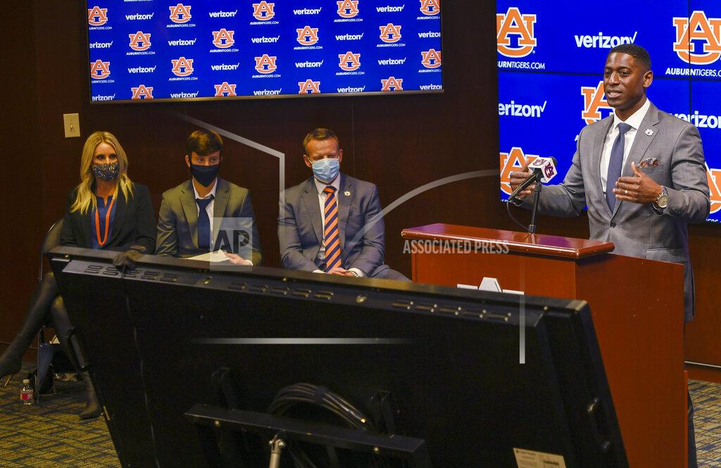 Todd Van Emst In this photo provided by Auburn Athletics, Auburn athletic director Allen Greene, right, introduces Bryan Harsin, third from left, Auburn's new football coach, Thursday, Dec. 24, 2020, in Auburn, Ala. (Todd Van Emst via AP)
