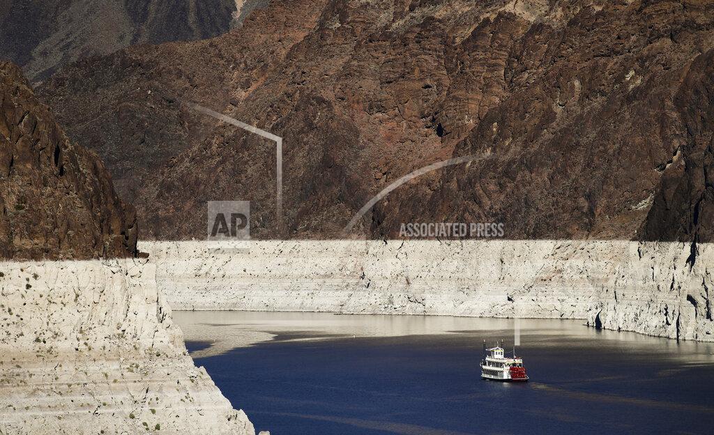 Jae C. Hong FILE - In this Oct. 14, 2015, file photo, a riverboat glides through Lake Mead on the Colorado River at Hoover Dam near Boulder City, Nev. The Bureau of Reclamation is forecasting first-ever water shortages because of falling levels at Lake Mead and says the reservoir could drop so low that it might not be able to generate electricity at Hoover Dam.(AP Photo/Jae C. Hong, File)