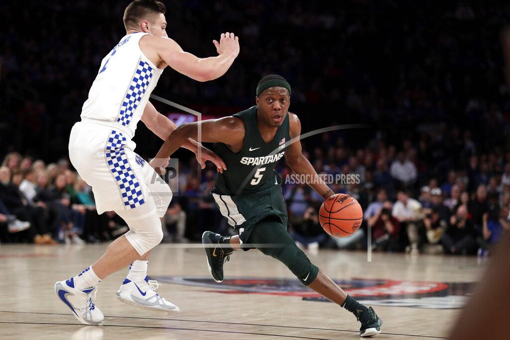 Adam Hunger Michigan State guard Cassius Winston (5) drives to the basket past Kentucky forward Nate Sestina (1) during the first half of an NCAA college basketball game Tuesday, Nov. 5, 2019, in New York. (AP Photo/Adam Hunger)