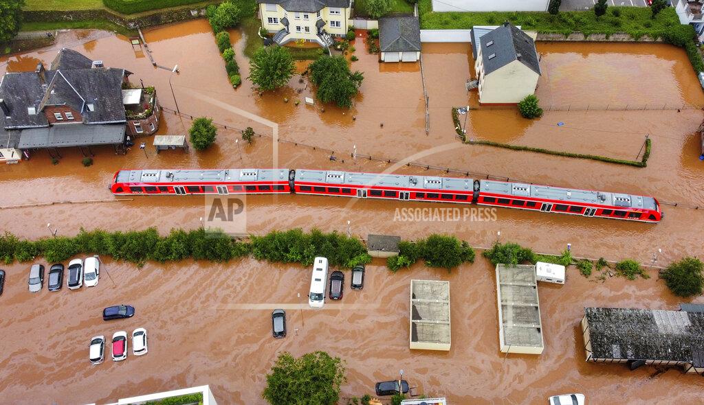 Sebastian Schmitt FILE - In this Thursday, July 15, 2021, 2021 file photo, a regional train in the flood waters at the local station in Kordel, Germany, after it was flooded by the high waters of the Kyll river. This summer a lot of the places hit by weather disasters are not used to getting extremes and many of them are wealthier, which is different from the normal climate change victims. That includes unprecedented deadly flooding in Germany and Belgium, 116-degree heat records in Portland, Oregon and similar blistering temperatures in Canada, along with wildfires. Now Southern Europe is seeing scorching temperatures and out-of-control blazes too. And the summer of extremes is only getting started. Peak Atlantic hurricane and wildfire seasons in the United States are knocking at the door. (Sebastian Schmitt/dpa via AP, File)