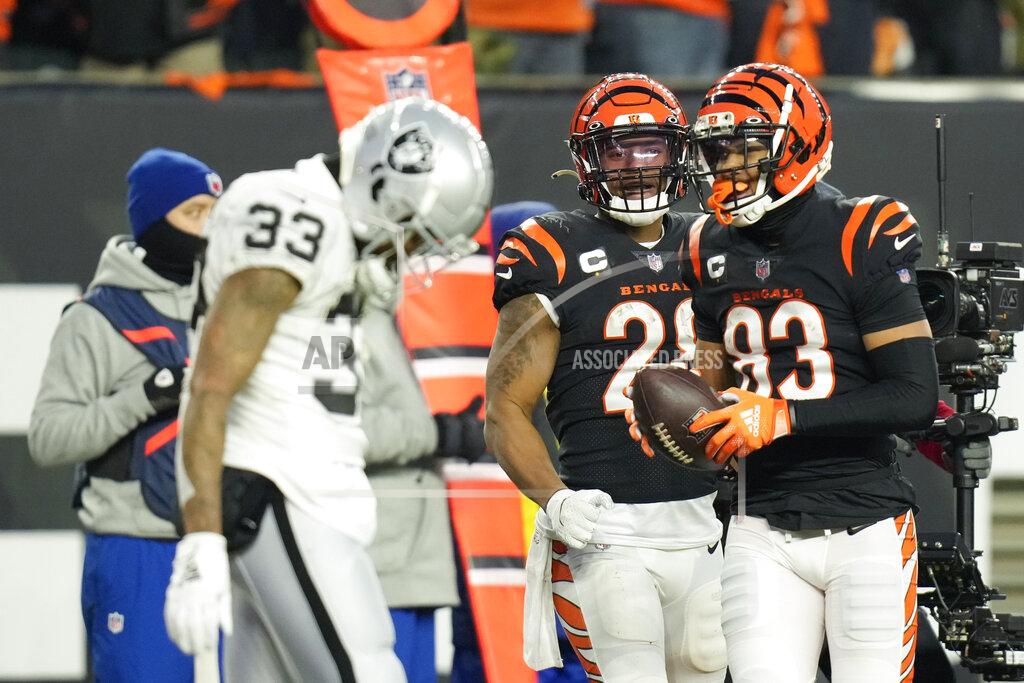 Aj Mast Cincinnati Bengals' Tyler Boyd (83) and Joe Mixon (28) react to a touchdown by Boyd in front of Las Vegas Raiders' Roderic Teamer (33) during the first half of an NFL wild-card playoff football game, Saturday, Jan. 15, 2022, in Cincinnati. (AP Photo/AJ Mast)