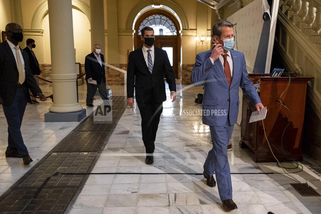 Ben Gray Georgia Gov. Brian Kemp leads Speaker of the House David Ralston, back left, and Lt. Gov. Geoff Duncan into a news conference Wednesday, Jan. 6, 2021, at the Georgia State Capitol in Atlanta. Kemp has denounced the violent protesters who stormed the U.S. Capitol, calling their actions a “disgrace and quite honestly un-American.” (AP Photo/Ben Gray)