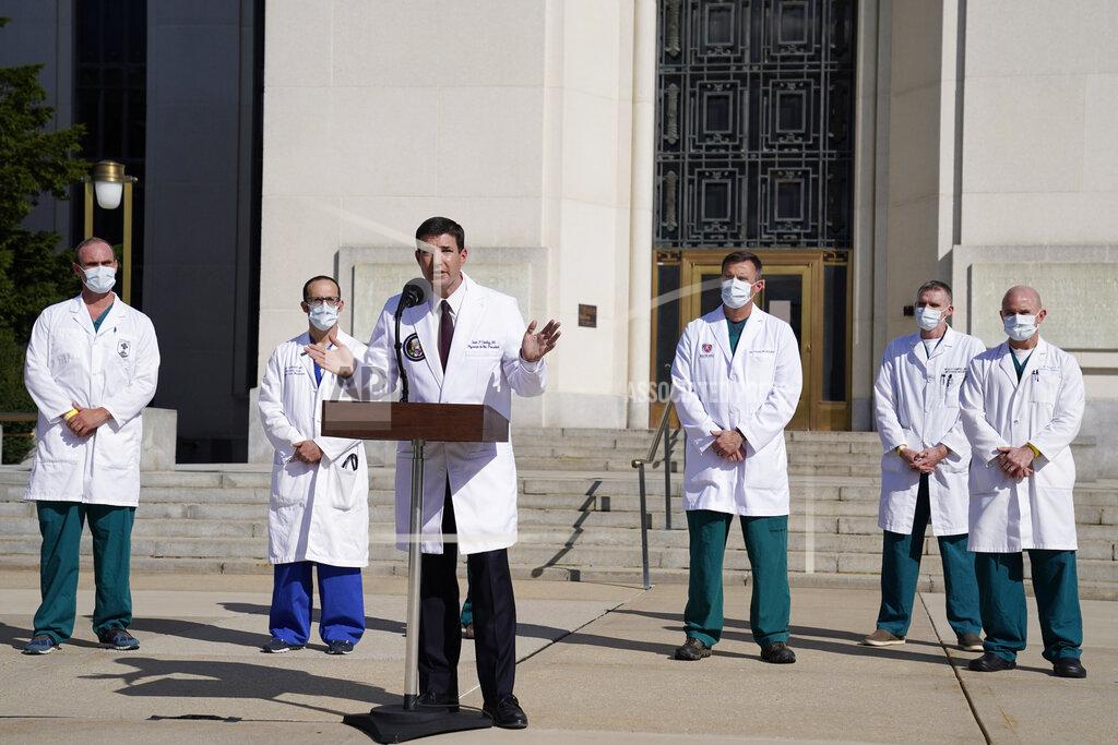 Evan Vucci Dr. Sean Conley, physician to President Donald Trump, center, talks with reporters at Walter Reed National Military Medical Center, Monday, Oct. 5, 2020, in Bethesda, Md. (AP Photo/Evan Vucci)