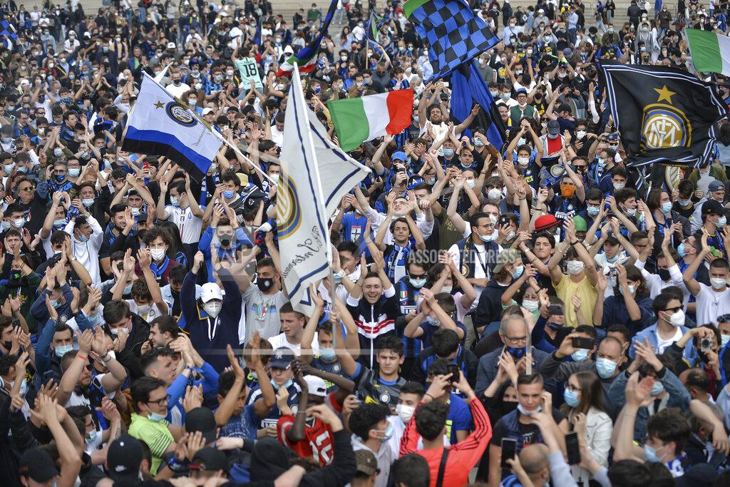 Claudio Furlan Inter Milan fans celebrate in Piazza Duomo square in front of the gothic cathedral after Inter Milan won its first Serie A title in more than a decade after second-placed Atalanta drew 1-1 at Sassuolo, in Milan, Italy, Sunday, May 2, 2021. Atalanta needed to win to avoid Inter mathematically clinching the title with four matches remaining. It was Inter’s first trophy since 2011 and the first Serie A title since 2010. (Claudio Furlan/LaPresse via AP)