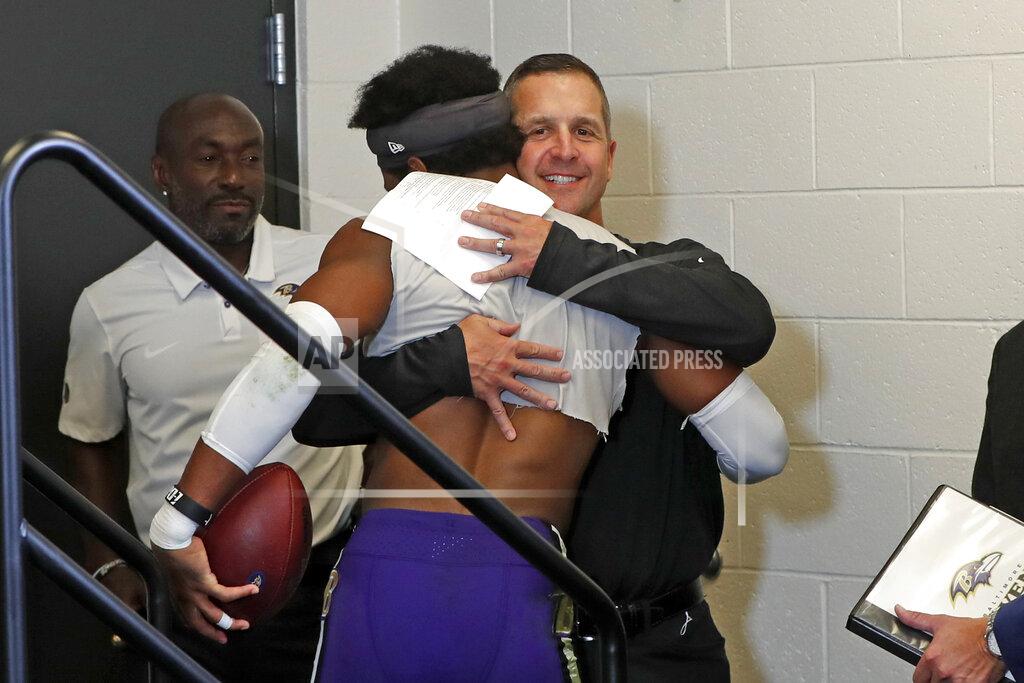 Gene J. Puskar Baltimore Ravens cornerback Marlon Humphrey, center left, gets a hug from head coach John Harbaugh, center right, after meeting with reporters after an overtime win over the Pittsburgh Steelers in an NFL football game in Pittsburgh, Sunday, Oct. 6, 2019. (AP Photo/Gene J. Puskar)