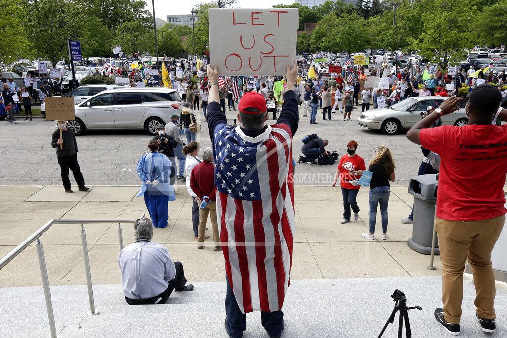 Gerry Broome People with ReopenNC gather in Raleigh, N.C., as they press Gov. Roy Cooper to allow businesses to reopen during the COVID-19 outbreak Tuesday, April 21, 2020. (AP Photo/Gerry Broome)