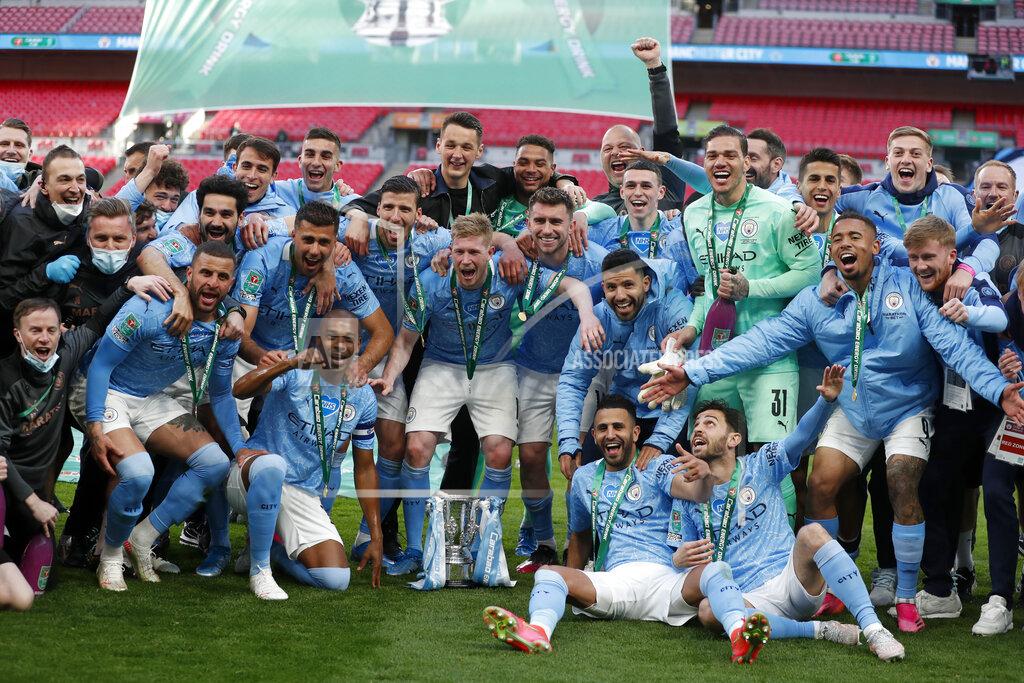 Alastair Grant Manchester City players celebrate with the trophy at the end of the English League Cup final soccer match between Manchester City and Tottenham Hotspur at Wembley stadium in London, Sunday, April 25, 2021. Manchester City won 1-0. (AP Photo/Alastair Grant)