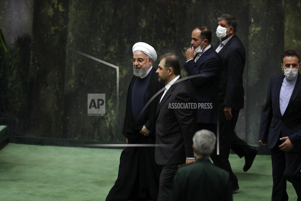 Vahid Salemi Iranian President Hassan Rouhani, left, arrives for the inauguration of the new parliament, in Tehran, Iran, Wednesday, May, 27, 2020. Iran has convened its newly elected parliament, dominated by conservative lawmakers and under strict social distancing regulations, as the country struggles to curb the spread of coronavirus that has hit the nation hard. Iran is grappling with one of the deadliest outbreaks in the Middle East. (AP Photo/Vahid Salemi)
