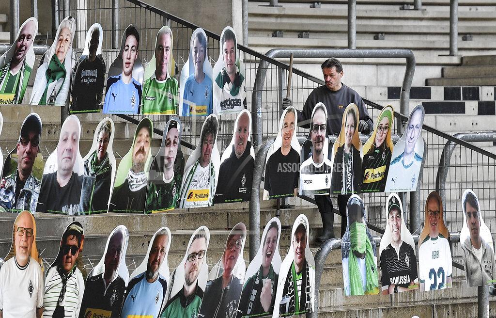 Portraits of fans of German Bundesliga soccer club Borussia Moenchengladbach are set on the supporters tribune in the stadium in Moenchengladbach, Germany, Thursday, April 16, 2020. All major events in Germany are suspended due to the coronavirus outbreak until the end of August, the German Bundesliga suspended all matches until April 30, 2020. (AP Photo/Martin Meissner)