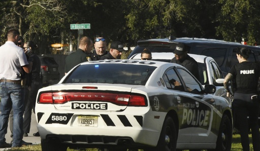 Multiple units from Palm Bay, Fla., and other police agencies gather along Emerson Drive and side streets Sunday afternoon, Jan. 28, 2024, where a shooting occurred. Four people are dead, including a Florida man accused of shooting and wounding two police officers, authorities confirmed Monday, Jan. 29. (Tim Shortt/Florida Today via AP)