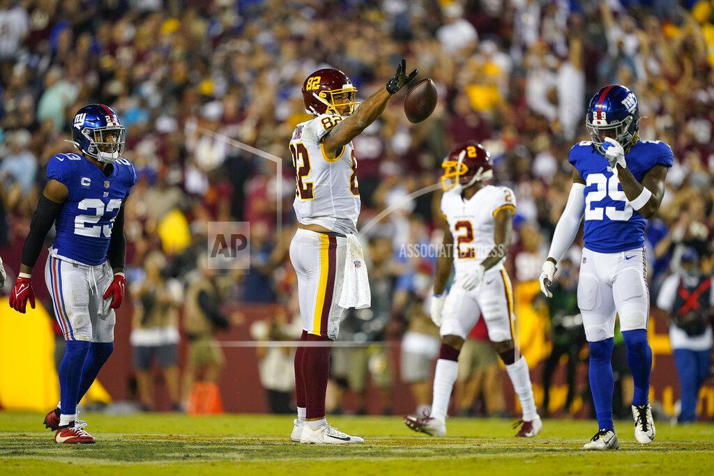 Al Drago Washington Football Team tight end Logan Thomas (82) releases the ball after making a successful catch for the first down against the New York Giants during the first half of an NFL football game, Thursday, Sept. 16, 2021, in Landover, Md. (AP Photo/Al Drago)