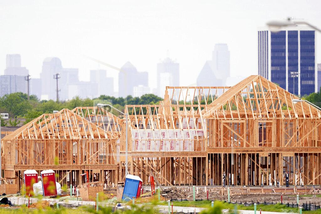 The frame of new home under construction sits in a neighborhood under development in north Dallas, Thursday, April 15, 2021. The first numbers from the 2020 census show southern and western states gaining congressional seats. The once-a-decade head count shows where the population grew during the past 10 years and where it shrank. (AP Photo/LM Otero)