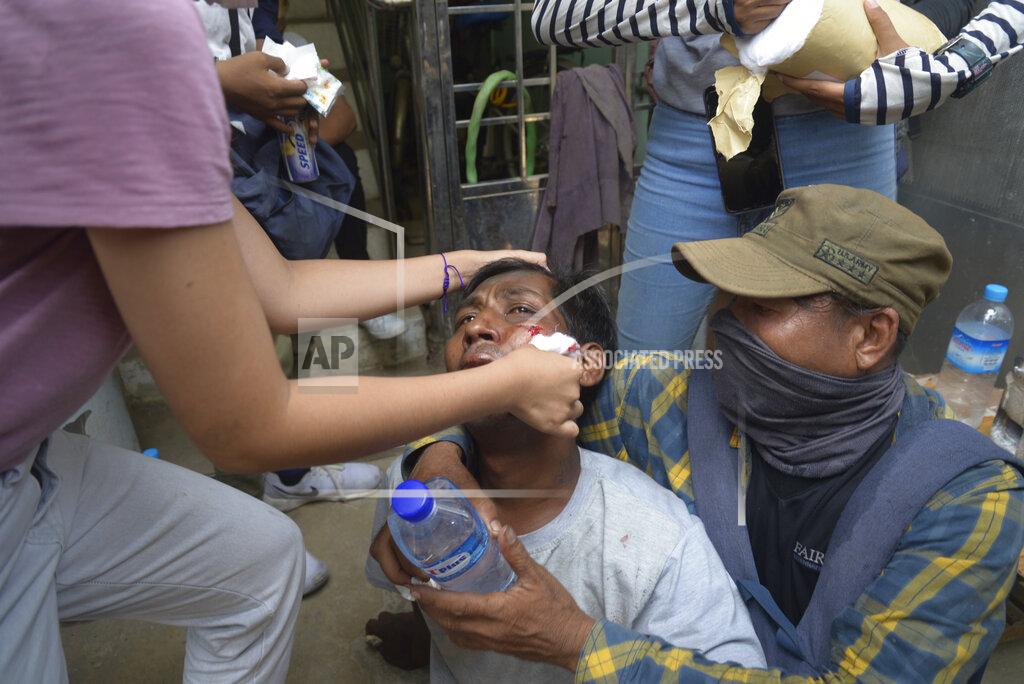 Uncredited Anti-coup protesters attend to an injured rallyist during a demonstration in Yangon, Myanmar on Tuesday March 30, 2021. Thailand’s Prime Minister Prayuth Chan-ocha denied Tuesday that his country’s security forces have sent villagers back to Myanmar who fled from military airstrikes and said his government is ready to shelter anyone who is escaping fighting. (AP Photo)