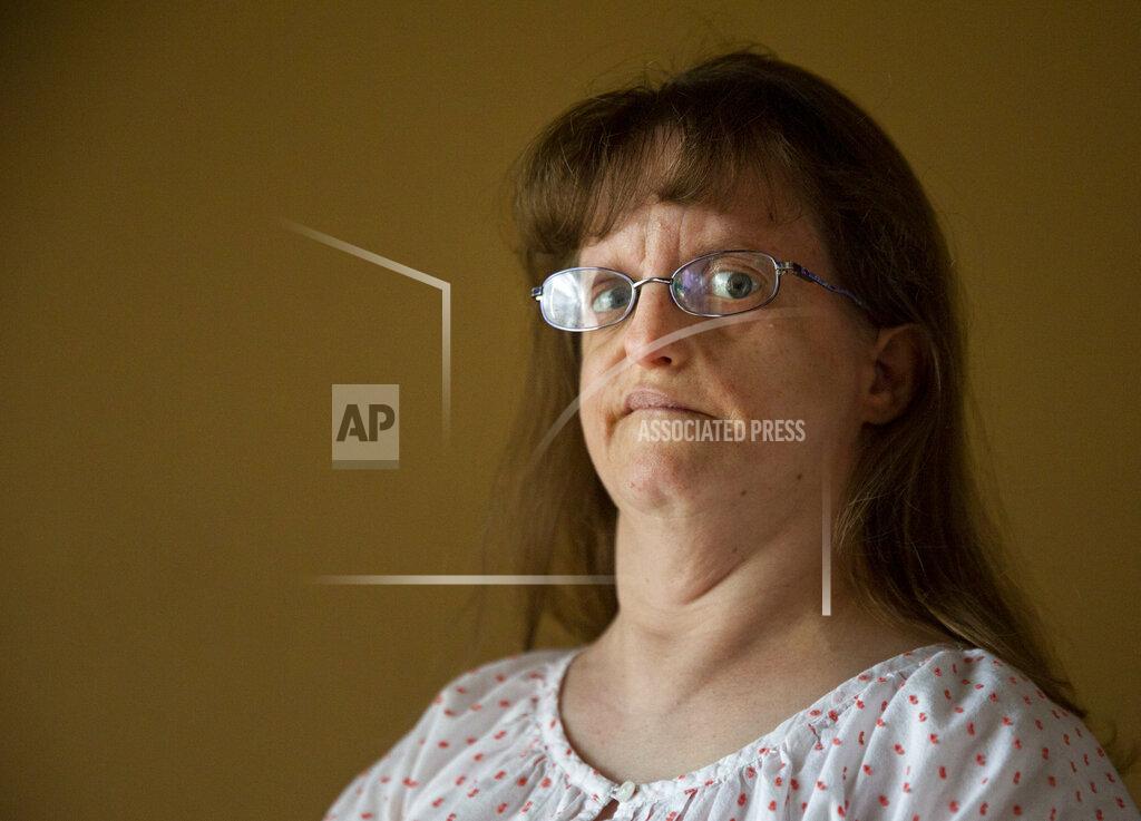 Sophia Germer Jen Dwyer, a 44-year-old woman with intellectual and developmental disabilities, poses at her home in Metairie, La., Friday, Sept. 17, 2021. (Sophia Germer/The Times-Picayune/The New Orleans Advocate via AP)