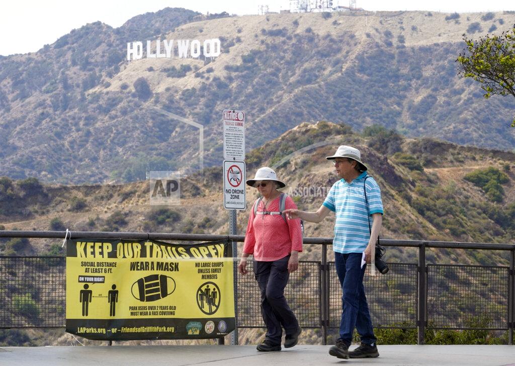 Damian Dovarganes Visitors are seen without face masks at the Griffith Observatory in Los Angeles, Monday, May 17, 2021. California is keeping its rules for wearing face masks in place until the state more broadly lifts its pandemic restrictions on June 15. (AP Photo/Damian Dovarganes)