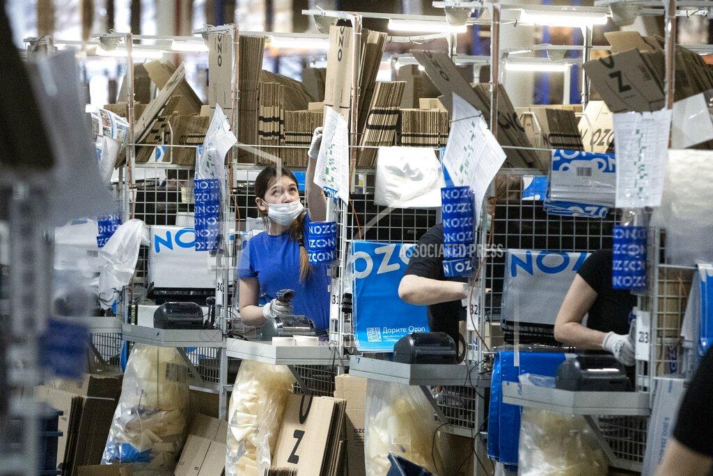 Pavel Golovkin Employees work at Ozon, a major Russian e-commerce platform similar to Amazon, in Moscow, Russia, Thursday, March 25, 2021. Ozon saw sales jump nearly 2.5 times last year, the company’s communications director Maria Zaikina said. (AP Photo/Pavel Golovkin)