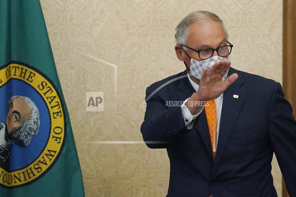 Ted S. Warren Washington Gov. Jay Inslee waves as he arrives to speak Thursday, June 3, 2021, during a news conference in Olympia, Wash. Inslee announced that Washington will be the latest state to offer prizes to encourage people to get vaccinated against COVID-19. Incentives will include a series of giveaways during the month of June including lottery prizes totaling $2 million, college tuition assistance, airline tickets, and game systems. (AP Photo/Ted S. Warren)