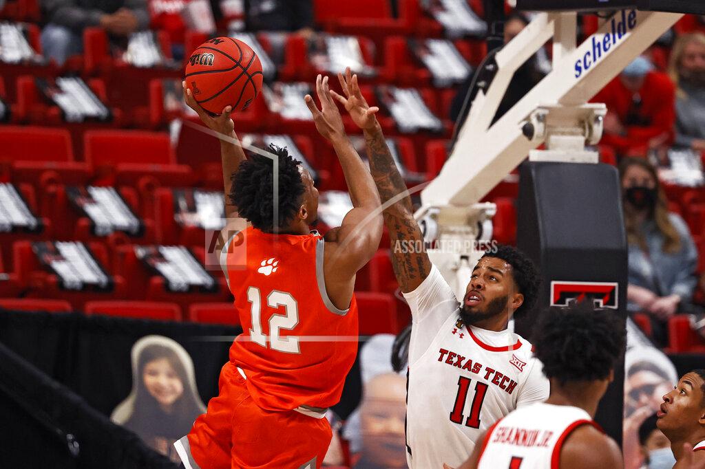 Brad Tollefson Sam Houston State's Tristan Ikpe (12) shoots the ball over Texas Tech's Kyler Edwards (11) during the first half of an NCAA college basketball game Friday, Nov. 27, 2020, in Lubbock, Texas. (AP Photo/Brad Tollefson)