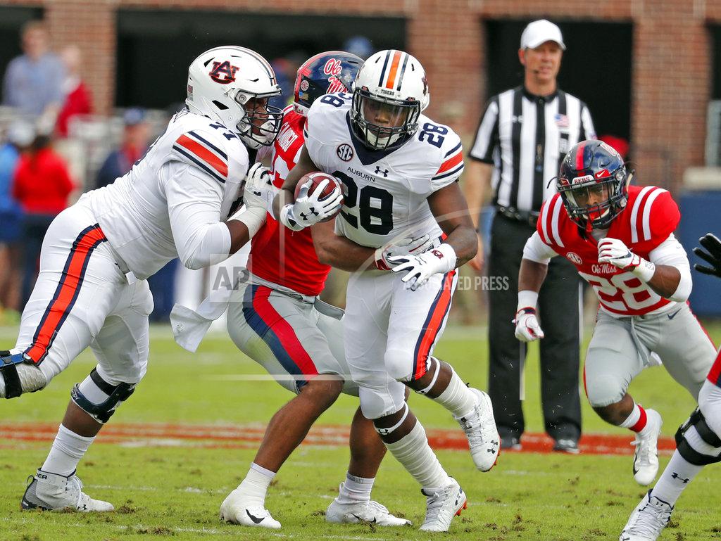 Rogelio V. Solis Auburn running back JaTarvious Whitlow (28) follows his blockers and runs for a short gain against Mississippi during the first half of an NCAA college football game on Saturday, Oct. 20, 2018, in Oxford, Miss. Auburn won 31-16. (AP Photo/Rogelio V. Solis)