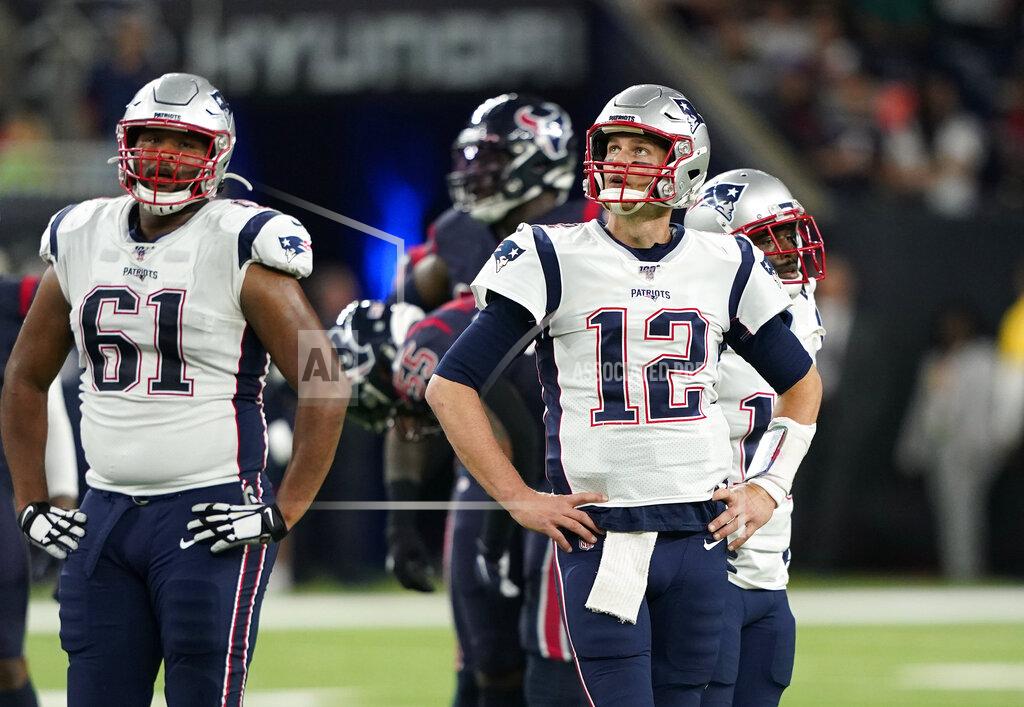 David J. Phillip New England Patriots quarterback Tom Brady (12) stands with teammates as a play is reviewed during the first half of an NFL football game against the Houston Texans Sunday, Dec. 1, 2019, in Houston. (AP Photo/David J. Phillip)