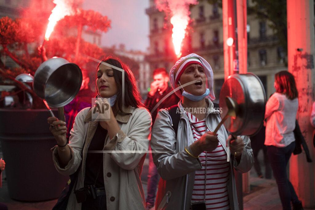 Daniel Cole FILE - In this Oct. 2, 2020, file photo, restaurant owners clang spoons and casseroles at a demonstration against restaurant and bar closures in Marseille, southern France. After entire nations were shut down during the first surge of the coronavirus earlier this year, some countries and U.S. states are trying more targeted measures as cases rise again around the world, especially in Europe and the Americas. Restaurant and bar owners in Marseille said the city was unfairly targeted last month for the nation's toughest virus rules at the time. (AP Photo/Daniel Cole, File)