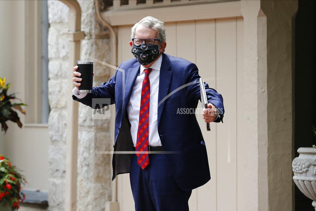 FILE—In this file photo from Aug. 6, 2020, Ohio Gov. Mike DeWine shrugs his shoulders in response to a reporter's question about him testing positive for COVID-19 in Bexley, Ohio. Ohio will use $50 million in federal pandemic aid dollars to buy two million at-home rapid coronavirus tests to help local health departments respond faster to testing needs, Gov. Mike DeWine announced Thursday, Jan. 21, 2021. (AP Photo/Jay LaPrete, File)