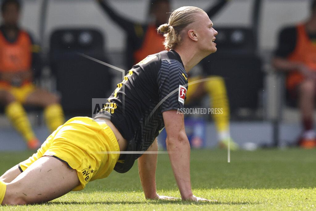 Daniel Karmann Dortmund's Erling Haaland lies on a German Bundesliga soccer match between Greuther Fuerth and Borussia Dortmund in Fuerth, Germany, Saturday, May 7, 2022. (Daniel Karmann/dpa via AP)